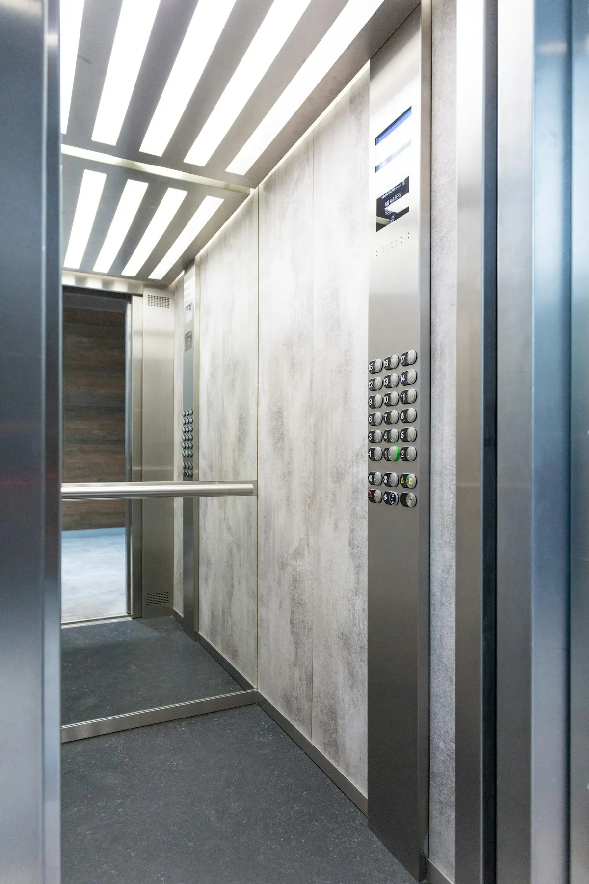 Passenger elevator doors in a modern loft-style interior